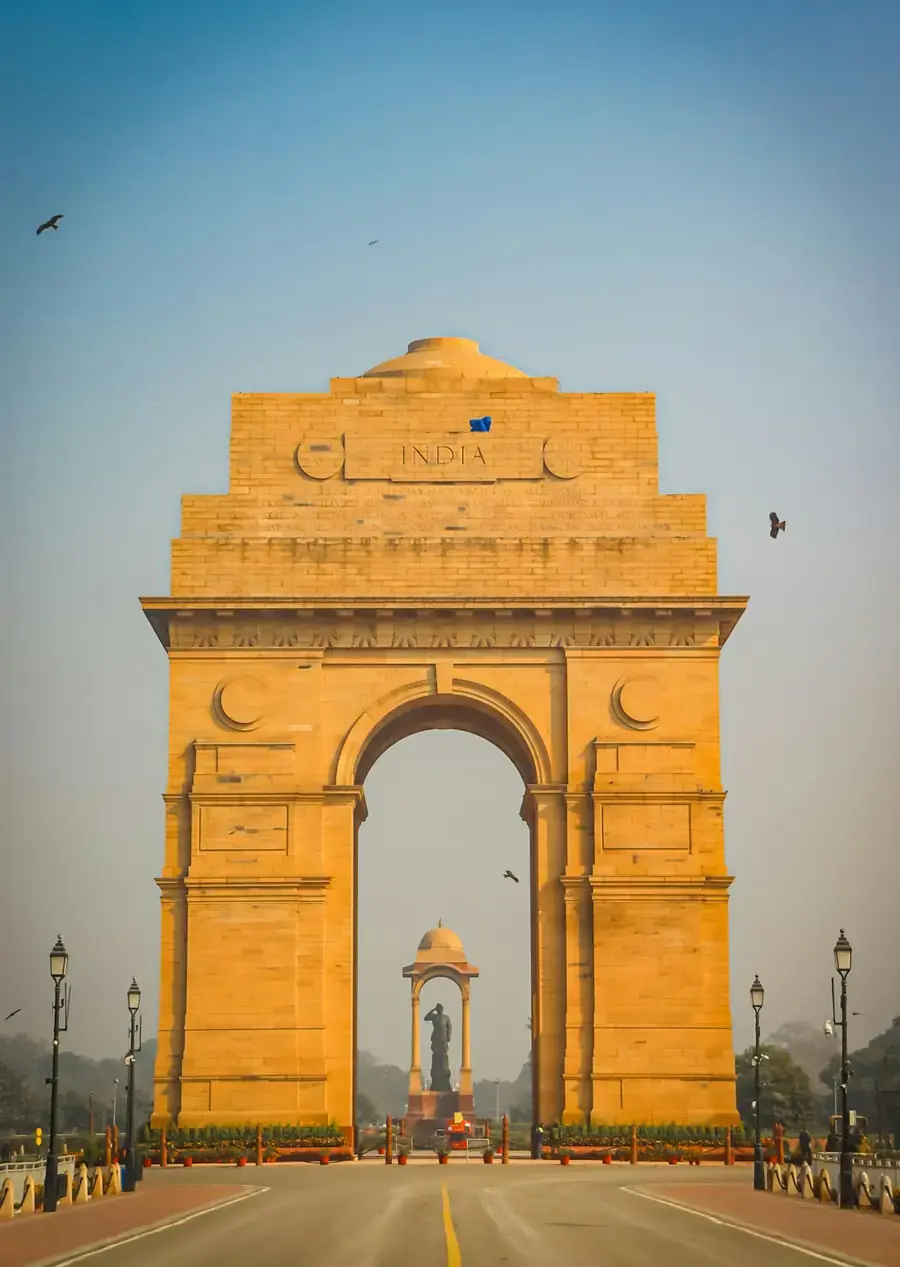 India Gate in New Delhi, with birds in the sky